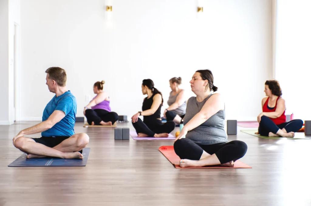 Students in cross legged pose in class